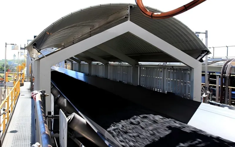 Coal on a conveyor belt. Coal on a conveyor belt being loaded onto a ship, the coal has motion blur
