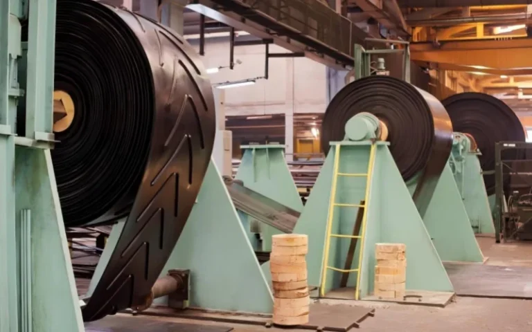The chevron conveyor belt is collecting rolls at the factory.