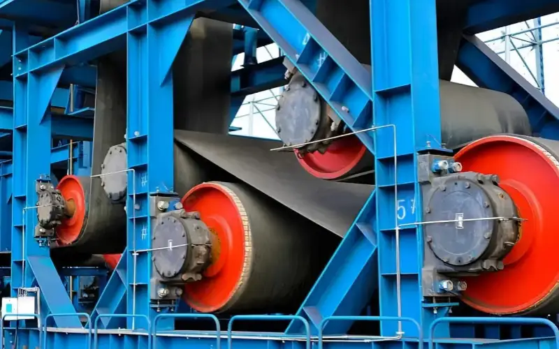 Adjust the conveyor belt tension rollers